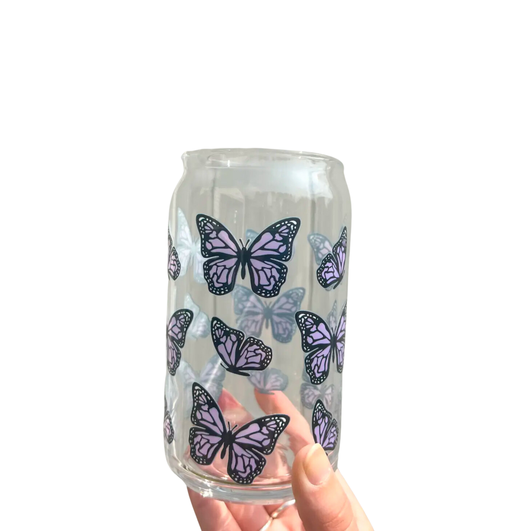 Glass cup with purple butterflies. This 16 oz can glass cup is a great choice for hot and cold beverages. Its butterfly design is printed seamlessly around the glass with high-quality, durable ink for long-lasting durability. Plus, it is dishwasher safe and can last through more than 300 dishwasher cycles on the top rack.