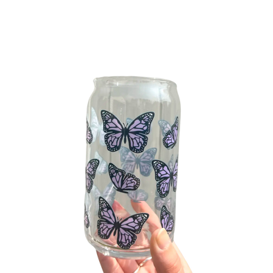 Glass cup with purple butterflies.  This 16 oz can glass cup is a great choice for hot and cold beverages. Its butterfly design is printed seamlessly around the glass with high-quality, durable ink for long-lasting durability. Plus, it is dishwasher safe and can last through more than 300 dishwasher cycles on the top rack.