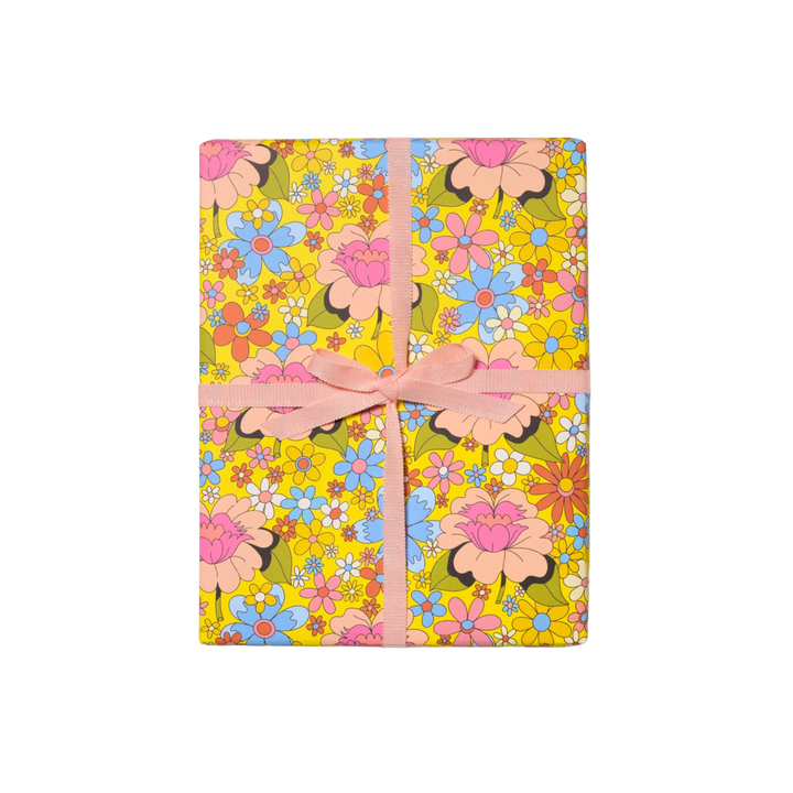 Colorful retro floral wrapping paper. Wrapped gift with Pink Bow