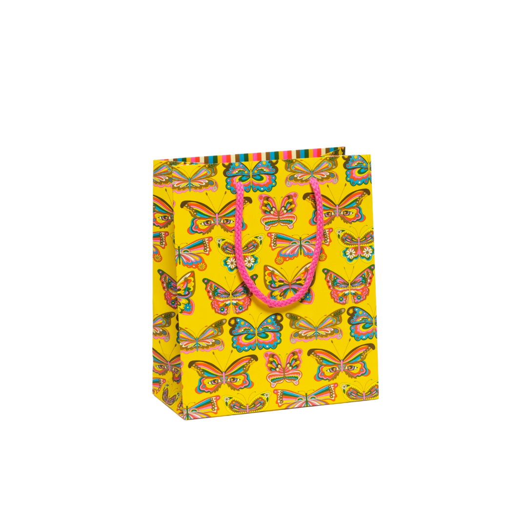 Colorful butterflies on yellow background with pink rope handle. Measuring 8 x 4 x 9.5 inches, this heavyweight coated paper gift bag features a cotton rope handle and illustrations by Krista Perry.