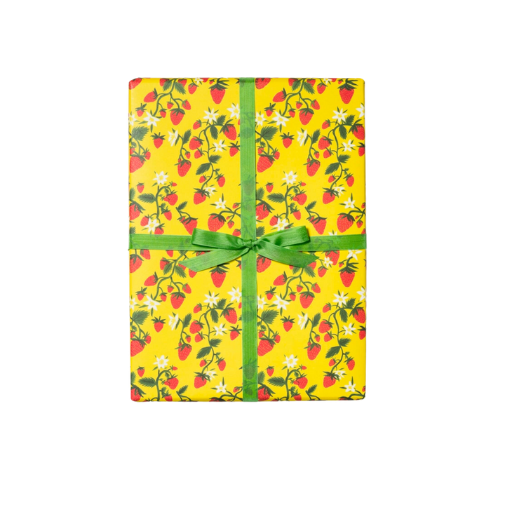 Illustrated strawberries on green stems with white flowers, on a yellow background. This package contains three 19 x 27 inch sheets of flat paper wrapping, rolled and tightly secured. Featuring artwork by Krista Perry, it is crafted in the United States of America.