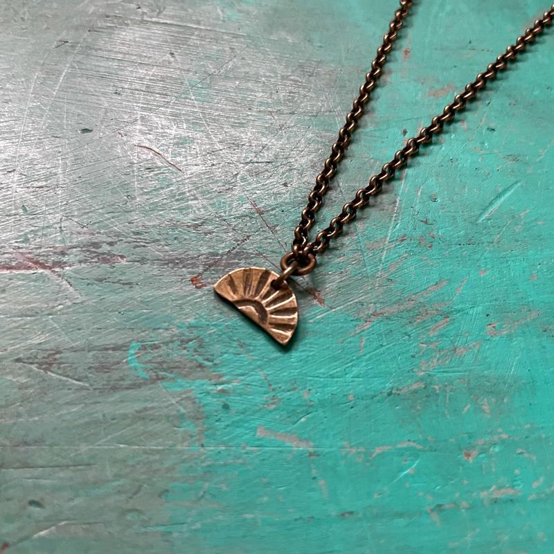 Tiny Brass Sunburst Necklace (downward facing)